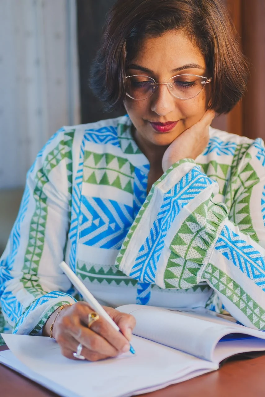 Dr Sonali Joshi, writing at a desk